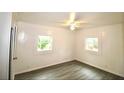 A bright, empty bedroom with wood-look flooring and white paneled walls at 1925 Kerry St, North Charleston, SC 29406