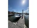 Boat docked near a pier with surrounding water and waterfront building in the background at 2 Mcdonough Rd # B-11, Folly Beach, SC 29439