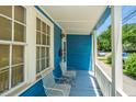 Inviting front porch featuring vintage metal chairs, perfect for relaxing and enjoying the neighborhood ambiance at 200 Fishburne St, Charleston, SC 29403