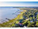 Expansive aerial view of Charleston with coastline, docks, homes with green trees and the Ravenel Bridge at 202 Bank St, Mount Pleasant, SC 29464