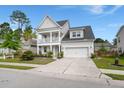 Attractive two-story home boasting a welcoming double porch, well-maintained lawn, and convenient two-car garage at 203 Yeamans Way, Summerville, SC 29483