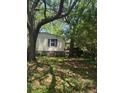 Backyard featuring mature trees providing ample shade, complemented by a fence and side yard access at 2041 Covey Ln, Charleston, SC 29412