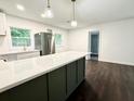 Bright open kitchen with a large island, stainless steel appliances, and modern pendant lighting at 208 Orange St, Walterboro, SC 29488