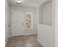 Bright entryway featuring neutral tile flooring, an alcove, white trim and walls, and a window with natural light at 215 Jackson St, Goose Creek, SC 29445