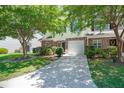 Inviting townhome with a one-car garage, manicured landscaping, and a long driveway, perfect for parking at 215 Jackson St, Goose Creek, SC 29445