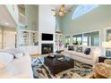 Bright and airy living room with vaulted ceilings, a fireplace, and built-in shelving at 2363 Palmer Creek Bnd, Charleston, SC 29412