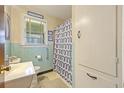 A retro-style bathroom featuring light blue tiling and a window at 2703 Phyllis St, North Charleston, SC 29405