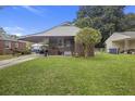 A brick home with a covered carport and a well-maintained lawn at 2703 Phyllis St, North Charleston, SC 29405
