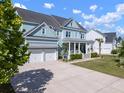 Charming two-story home with a welcoming front porch, three car garage and a long driveway at 2917 River Vista Way, Mount Pleasant, SC 29466