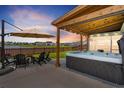 Relaxing backyard featuring a covered patio with a hot tub, seating area, and a view of the water at 302 Lucca Dr, Summerville, SC 29486