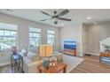 Inviting living room with a ceiling fan, light walls, and wood-look floors for a modern aesthetic at 313 Lanyard St, Johns Island, SC 29455