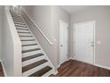 Bright entryway featuring hardwood floors and a staircase with white banister at 354 Iveson Rd, Summerville, SC 29486
