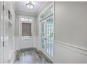 Bright foyer with wood-look flooring, glass panel door to office and door to the exterior at 359 Whispering Breeze Ln, Summerville, SC 29486