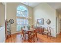 Bright dining room with a large window, hardwood floors, chandelier, and traditional-style wooden furniture at 416 Prestwick Ct, Summerville, SC 29483