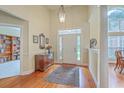 Spacious foyer with hardwood floors, large windows and a decorative rug and wooden accent table at 416 Prestwick Ct, Summerville, SC 29483
