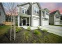Two-story home featuring a welcoming front porch, tidy landscaping, and a spacious two-car garage at 436 Rowley Ln, Summerville, SC 29486