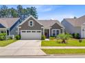 Charming single story home with landscaped yard and a two car garage at 5078 Song Sparrow Way, Summerville, SC 29483