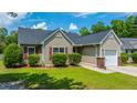 Attractive one story home featuring red shutters, green shrubs, manicured lawn, and an attached single-car garage at 5128 Thornton Dr, Summerville, SC 29485