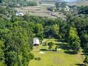 Expansive wooded property with a horse barn, paddock, and fenced training ring near winding creeks at 6434 Saint Anthony Dr, Meggett, SC 29449