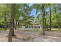 Charming two-story home with a screened porch nestled among mature trees, offering privacy at 6434 Saint Anthony Dr, Meggett, SC 29449