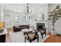 Bright living room with hardwood floors, fireplace, chandelier, and classic architectural details at 71 E Bay St, Charleston, SC 29401