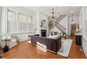 Elegant living room featuring hardwood floors, a fireplace, a staircase, and natural light at 71 E Bay St, Charleston, SC 29401