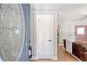 Inviting foyer with decorative glass door, white trim, and glimpse into the living room at 7639 Hillandale Rd, North Charleston, SC 29420