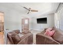 Cozy living room featuring hardwood floors, a ceiling fan, and natural light from large windows at 7639 Hillandale Rd, North Charleston, SC 29420