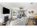 Bright living room with fireplace, sliding glass doors to patio, and an adjacent dining area at 7935 Parklane Ct # A, North Charleston, SC 29418