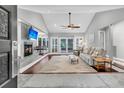 Bright living room with fireplace, hardwood floors, and sliding glass doors to the backyard at 8 Pony Ln, Charleston, SC 29407