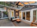 Relaxing covered patio with hot tub, ceiling fan, and comfortable seating area at 8 Pony Ln, Charleston, SC 29407