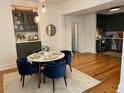 Inviting dining area with stylish chairs, hardwood floors, and seamless kitchen access at 84 Bull St # F, Charleston, SC 29401