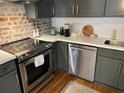 Modern kitchen features stainless steel appliances, white countertops, and brick accents at 84 Bull St # F, Charleston, SC 29401