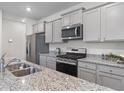 Modern kitchen featuring stainless steel appliances, granite countertops and grey cabinets at 849 Kirby Ct, Charleston, SC 29414