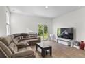 Spacious living room with a large sectional couch and sliding glass doors to backyard at 849 Kirby Ct, Charleston, SC 29414