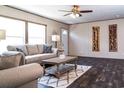 Bright living room features wood-look floors, a ceiling fan, and ample natural light at 934 Tiger Loop, Saint Stephen, SC 29479