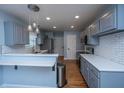 Updated kitchen with breakfast bar, pendant lighting, stainless steel appliances and tile backsplash at 1005 Trotters Blvd, Summerville, SC 29483