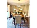 Elegant dining room features hardwood floors, colorful rug, and stylish chandelier over the wooden table at 1015 Jacksnipe Ln, Mount Pleasant, SC 29464