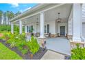 Inviting front porch with stone accents, comfortable seating, and tasteful landscaping, creating a warm entryway at 1059 Fitzgerald Ct, Summerville, SC 29485