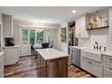 An open kitchen features a kitchen island, stainless steel appliances, white cabinetry, and a breakfast nook at 109 Lakeview Dr, Summerville, SC 29485