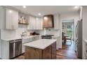 Bright kitchen featuring white cabinets, a farmhouse sink, butcher block island, and modern appliances at 109 Lakeview Dr, Summerville, SC 29485