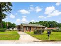 Cozy home featuring a fenced yard and concrete driveway at 109 Rahway Rd, Goose Creek, SC 29445