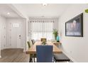 Bright dining room features hardwood floors, natural light, and table that sits six people comfortably at 132 Wild Holly Dr, Moncks Corner, SC 29461
