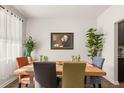 Dining room with hardwood floors, modern art, and table that sits six people comfortably at 132 Wild Holly Dr, Moncks Corner, SC 29461