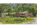 Traditional brick home with a lush front yard and established landscaping at 1549 N Avalon Cir, Charleston, SC 29407