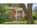 Inviting front porch featuring brick steps, a white railing, and partial shade at 1549 N Avalon Cir, Charleston, SC 29407
