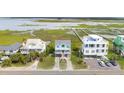 Charming coastal home with double balconies, offering picturesque marsh views in an elevated setting at 1568 E Ashley Ave, Folly Beach, SC 29439