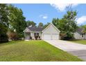 Inviting one-story home with a well-maintained lawn, charming front porch, and a convenient two-car garage at 1578 Stanwick Dr, Johns Island, SC 29455