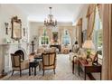Bright living room features a fireplace, chandelier, and classic furnishings, creating a refined space at 16 Trumbo St, Charleston, SC 29401