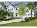 Elegant home with a two-car garage, concrete driveway, manicured lawn, and a charming covered front porch at 1723 Bolden Dr, Mount Pleasant, SC 29466